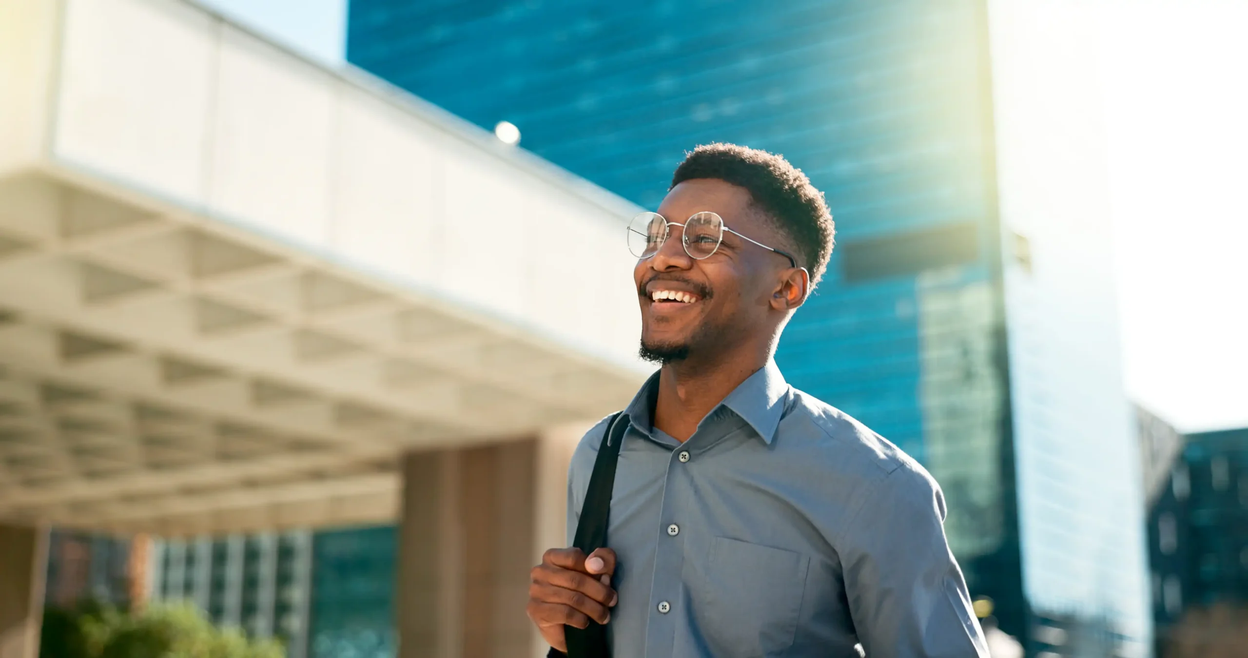 Professional man smiling on his way into the office