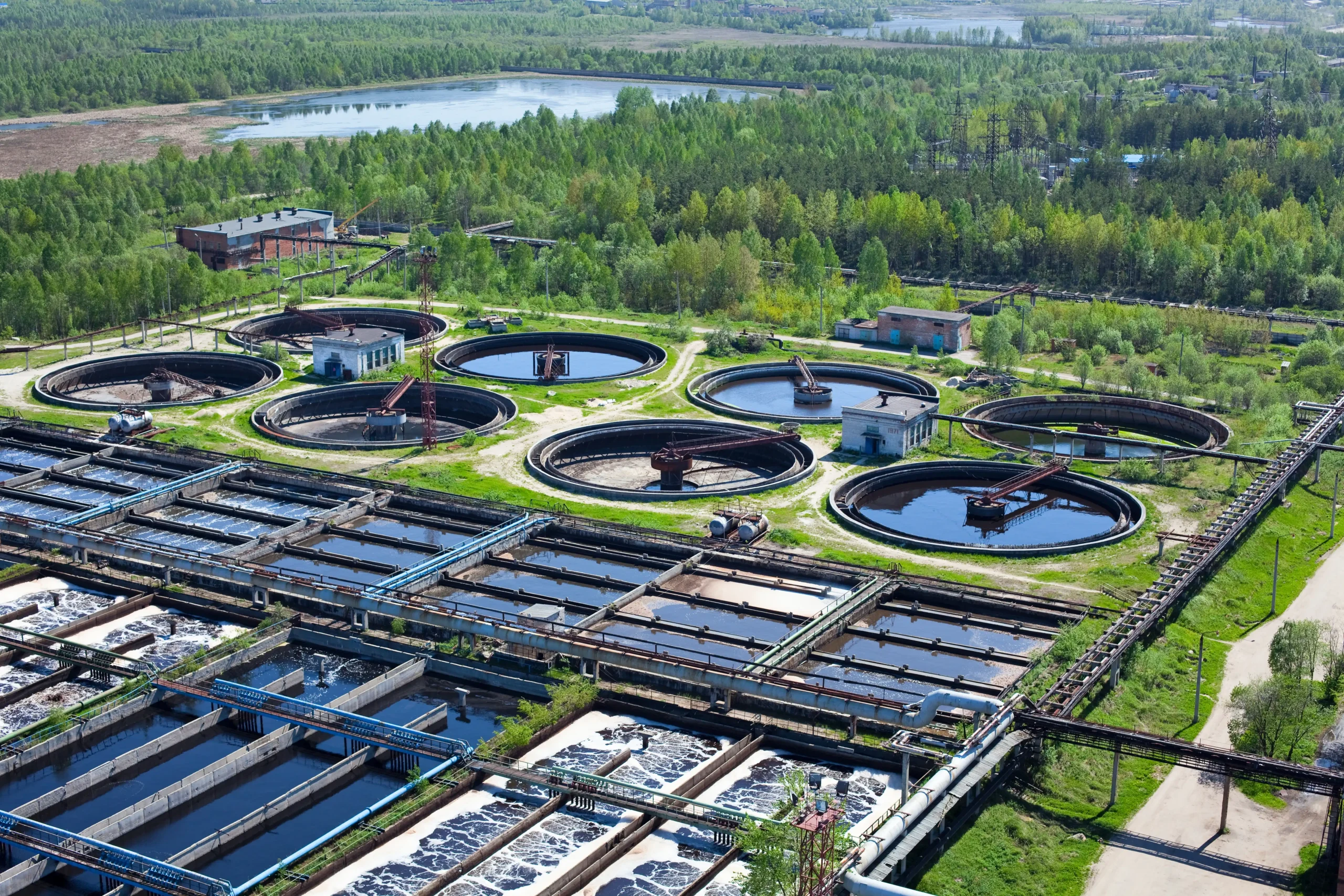 Aerial photo of a large water treatment facility surrounded by forest