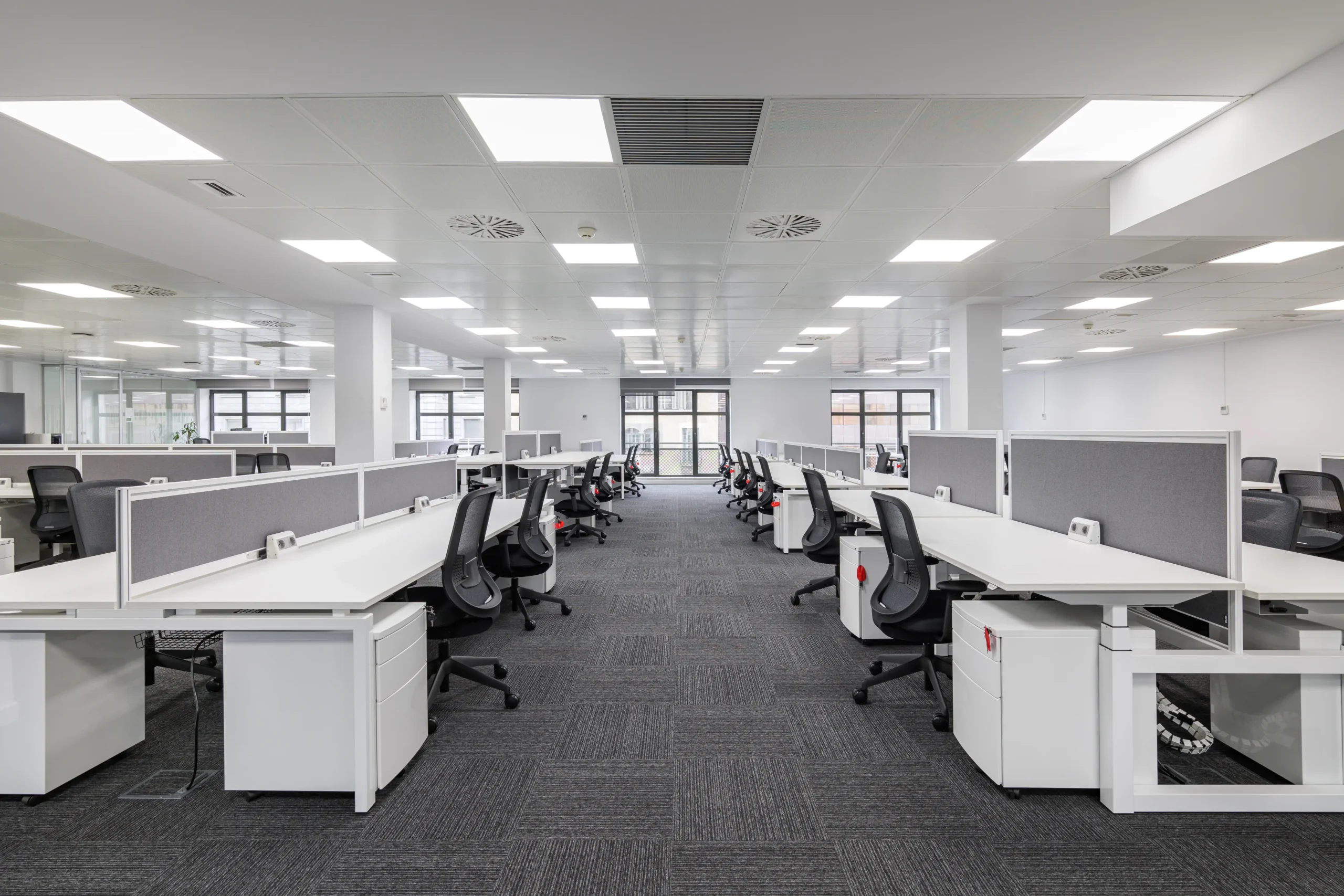 Rows of office desks sit empty
