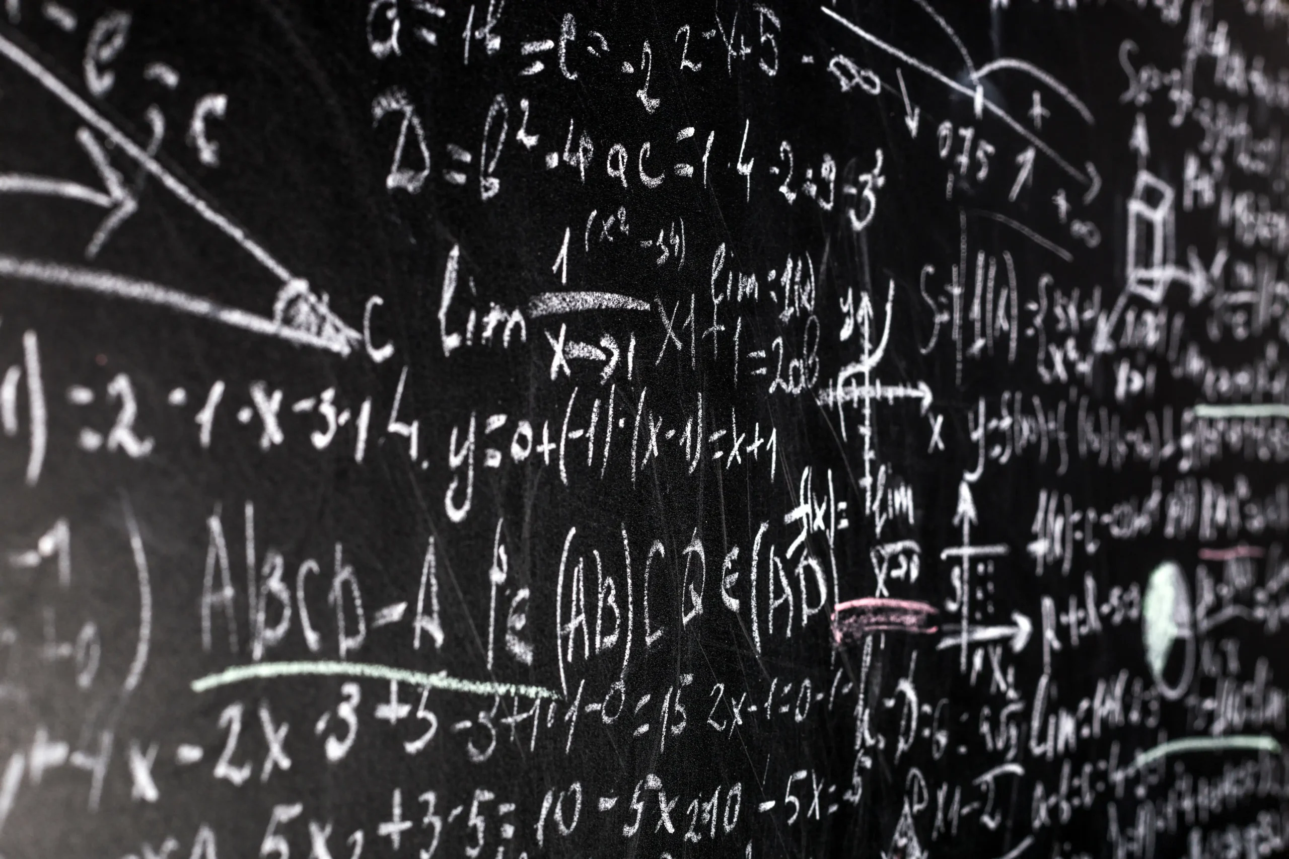 Large, complex math problem written on a chalk board