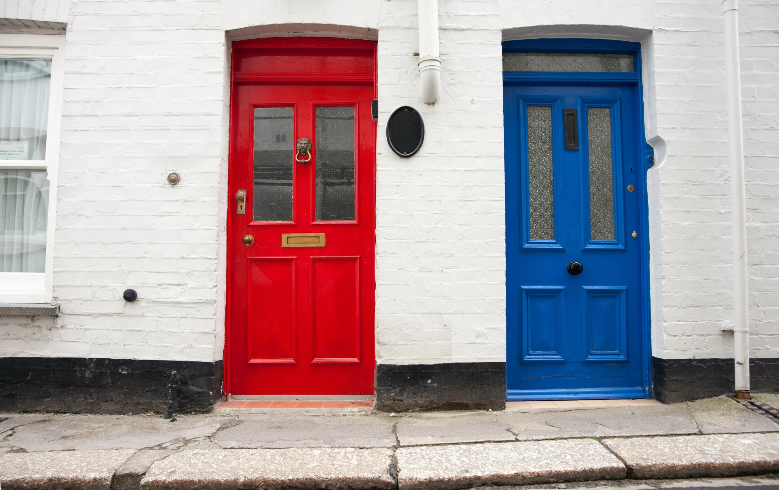 Two front doors next to each other, one red, one blue
