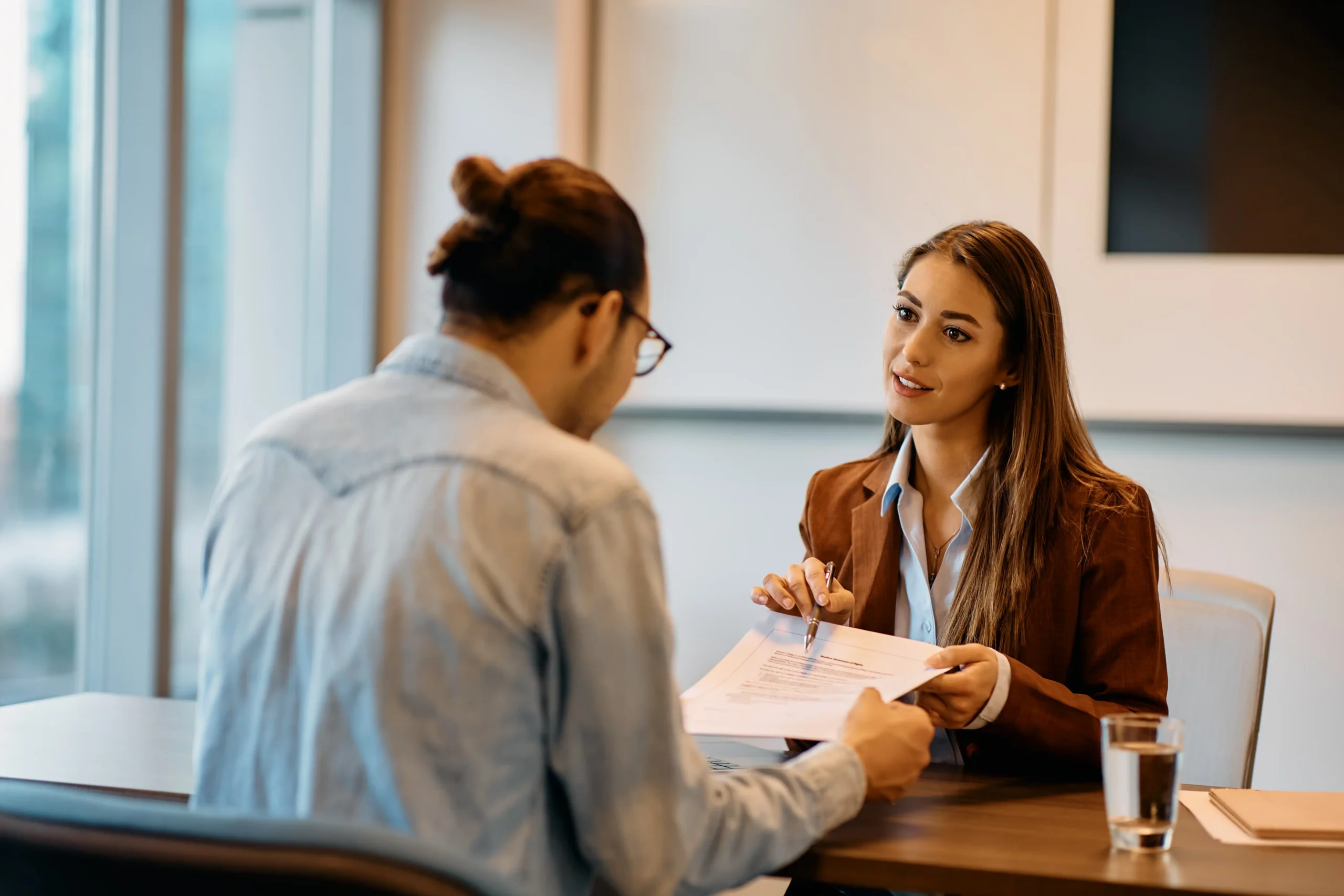 HR representative and employee discussing a case at a shared desk
