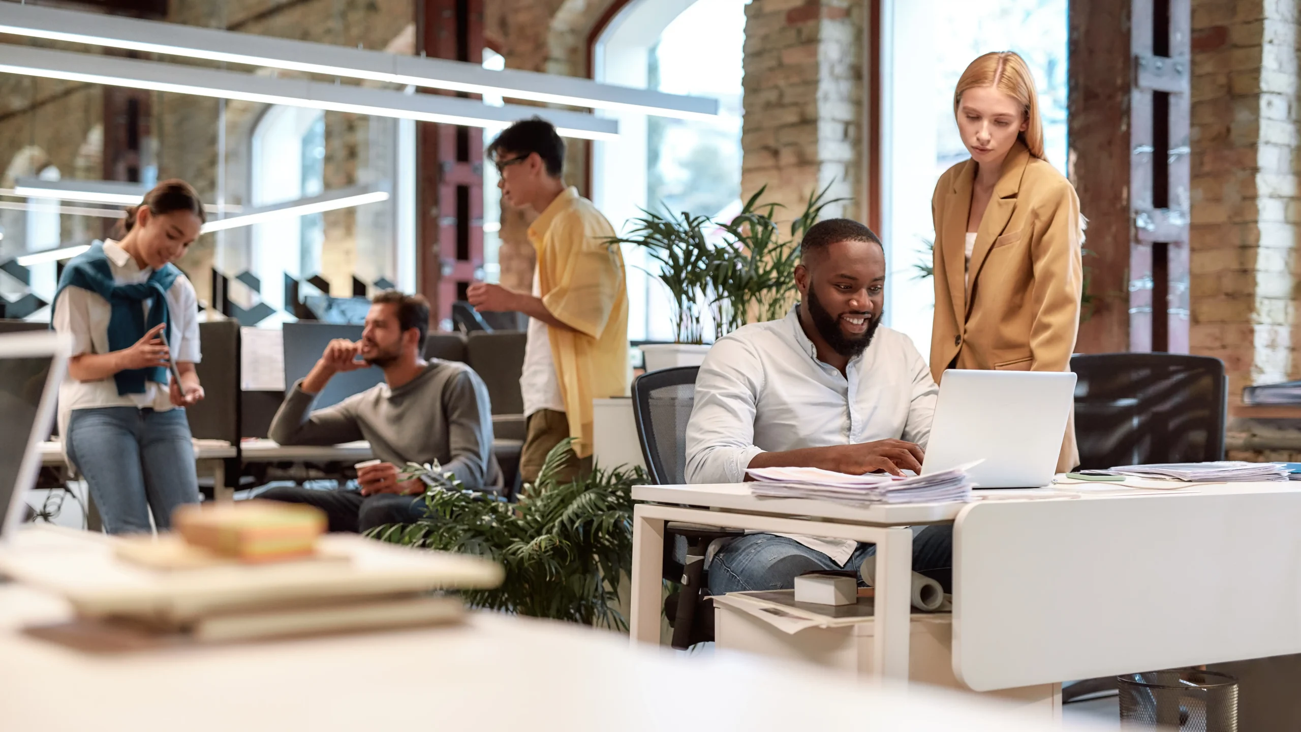 coworkers mingling in open office space