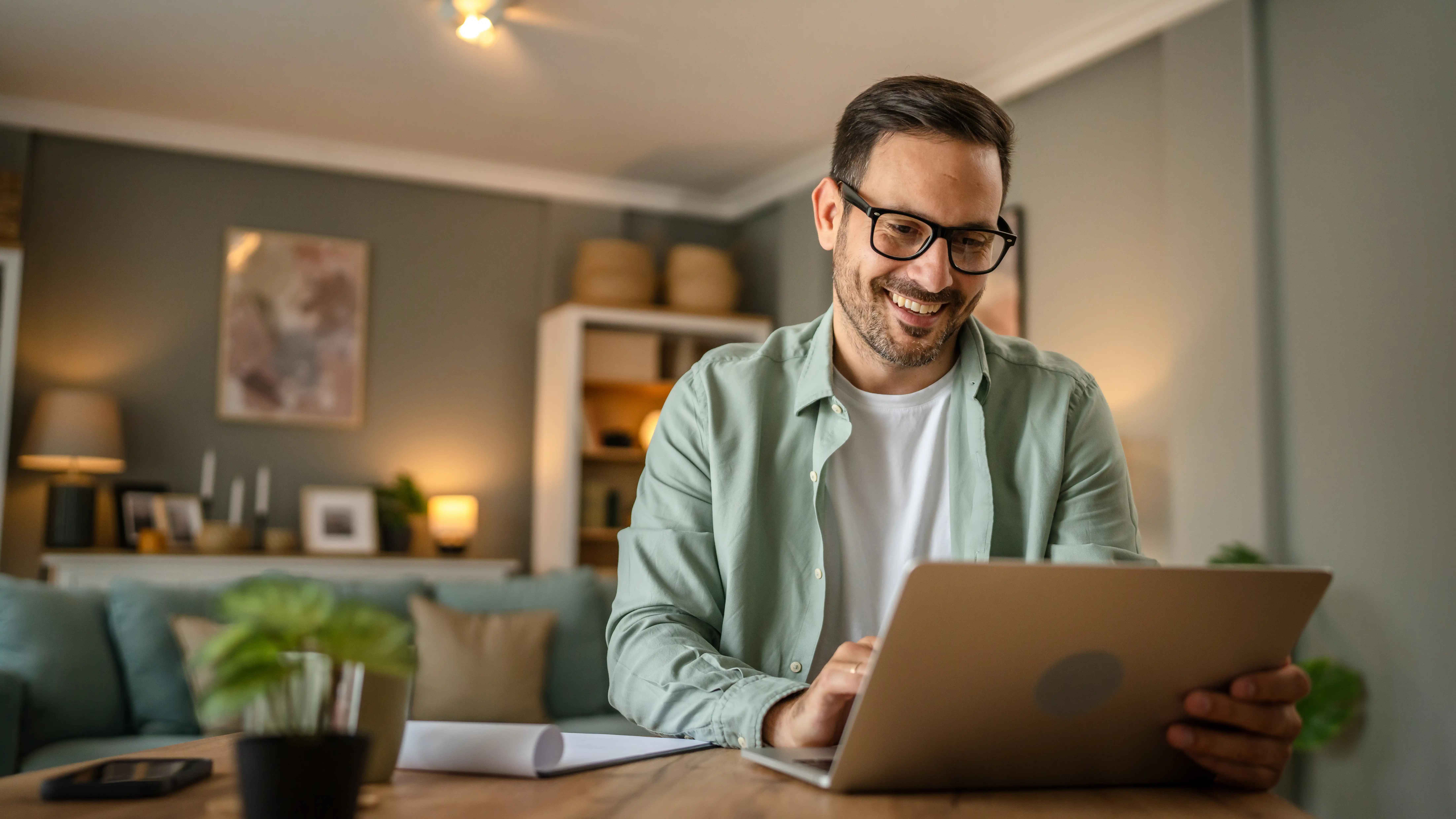 happy guy at home office smiling at his accomplishment