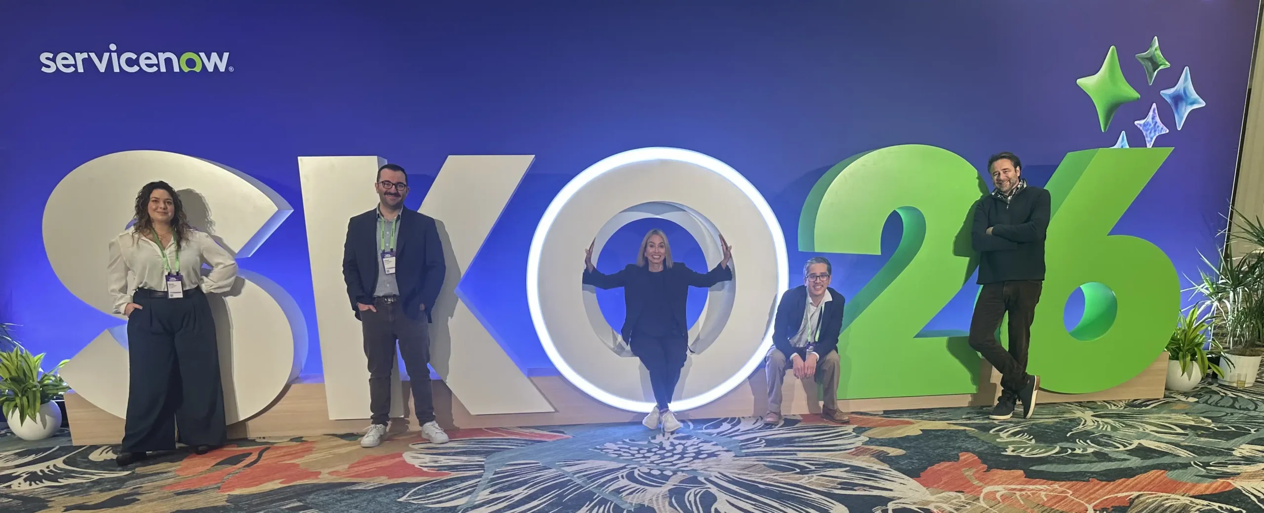 Team standing in front of SKO26 sign
